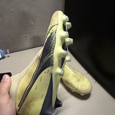 Yellow Puma football boots with studs