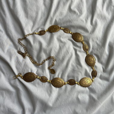 Gold-colored link chain with ornaments