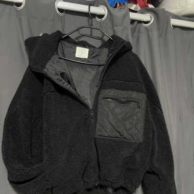 Veste noire avec poche sur l’avant gauche 