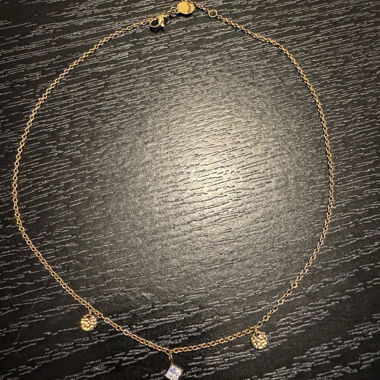 Gold-coloured necklace with pendants