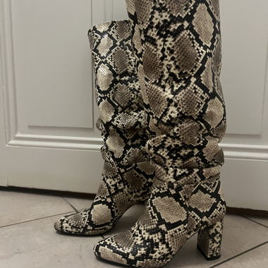 Snake print knee-high heeled boots