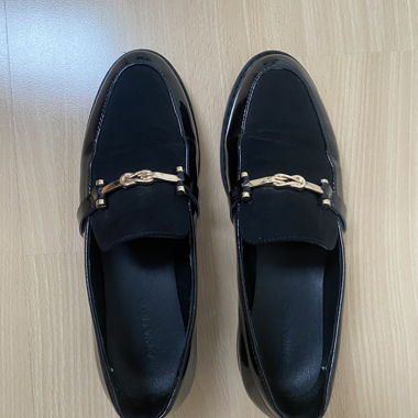 Black loafers with gold detail