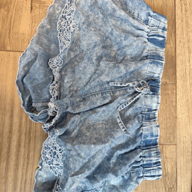 Light blue denim shorts with lace trim