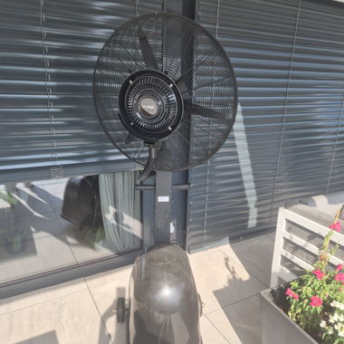 Large black fan with mist sprayer on wheels 