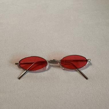 Narrow oval sunglasses with red lenses