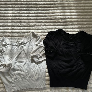 Two knit sweaters in black and white