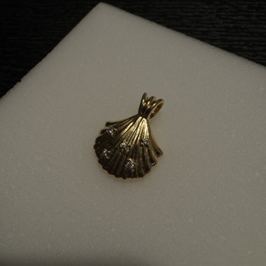 Golden shell pendant with stones