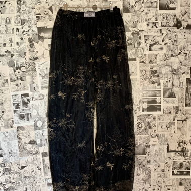 Pantalon en mesh superposé avec détails dorés