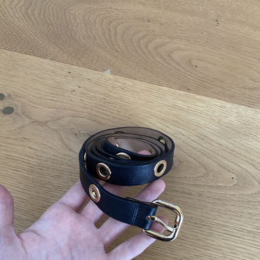 Black belt with golden holes