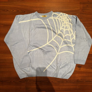 Maglione azzurro chiaro con motivo ragnatela
