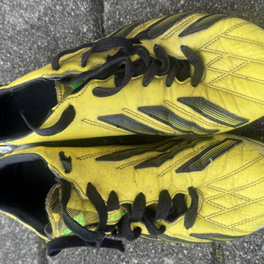 Yellow football boots with studs