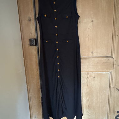 Long black sleeveless dress with gold buttons