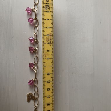 Gold chain bracelet with pink crystals