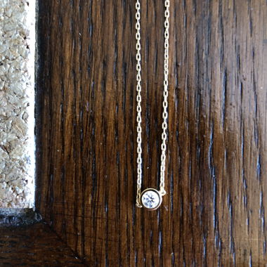Gold necklace with a sparkling rhinestone