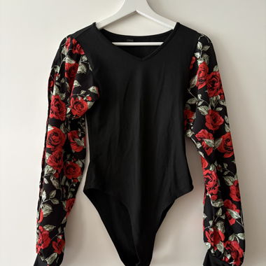 Black bodysuit with red floral sleeves