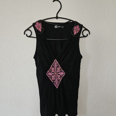 Black sleeveless top with pink embroidery