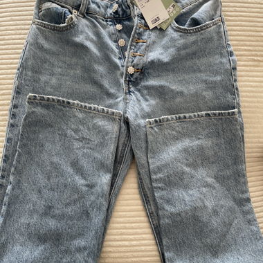 Light blue mom jeans with decorative buttons