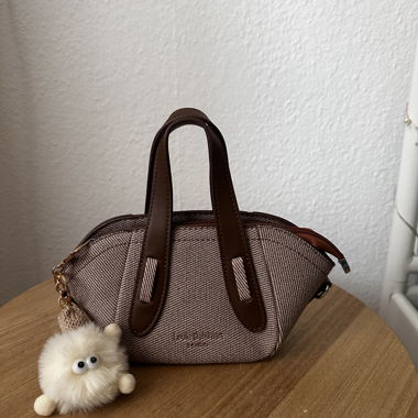 Kleine braune Handtasche mit Plüschanhänger