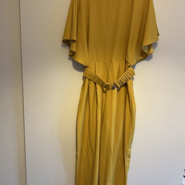 Yellow jumpsuit with belt and open back