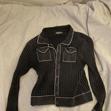 black cardigan with white stitching 