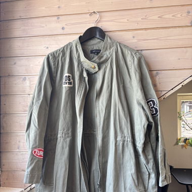 camouflage green jacket with patches