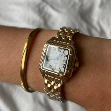 gold lady‘s watch with blue detail