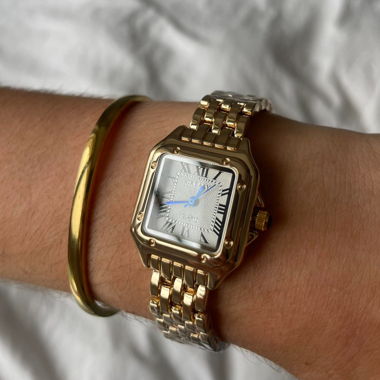 gold lady‘s watch with blue detail