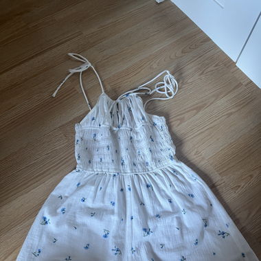 Smocked playsuit with blue flowers 