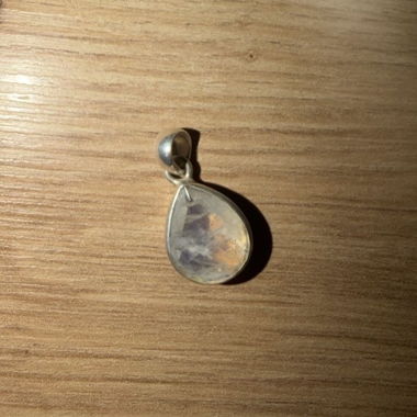 Silver-colored teardrop pendant with moonstone
