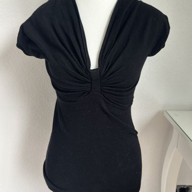 Top stile baby‑doll con fiocco davanti