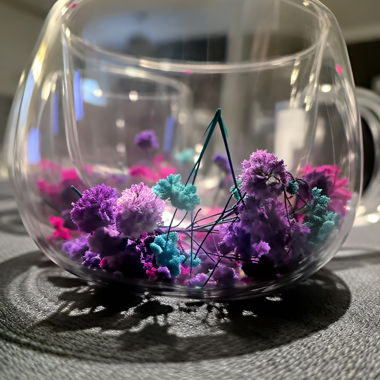Glass cups with colorful dried flowers