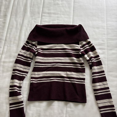 Off-shoulder bordeaux red top with white stripes.