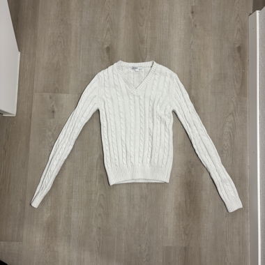 Subdued white cable-knit sweater