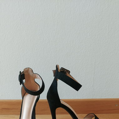 Black suede high heels with buckle closure