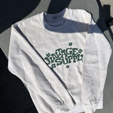 Pull-Sweat beige à motifs verts