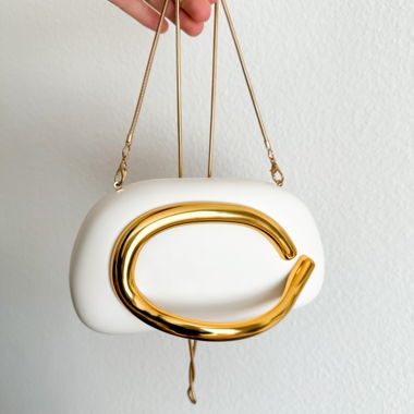 White mini clutch with gold handle and chain