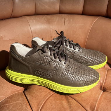 Brown Nike woven-leather sneakers with yellow sole
