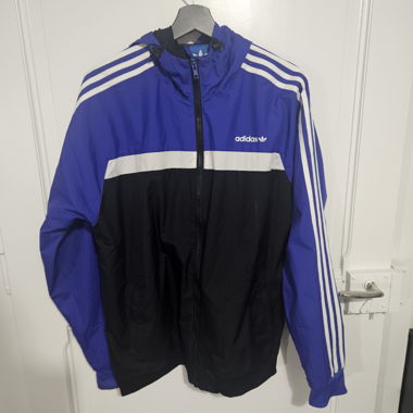Giacca a vento Adidas blu/nero