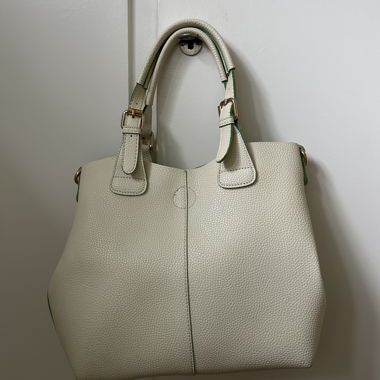 White handbag with green inner lining