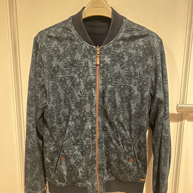 Reversible bomber jacket with blue foliage pattern
