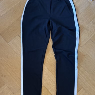 Black sports pants with side stripes