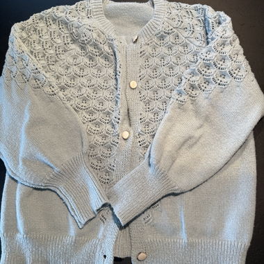 Light blue knitted cardigan with openwork pattern