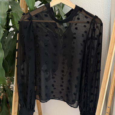 Blusa nera trasparente con pois in rilievo