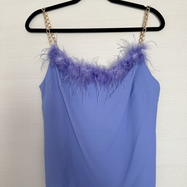 Women's top in purple with feathers and gold chain straps