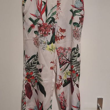 White fabric trousers with flowers
