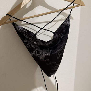 Crop-Tops schwarz mit Drachenmotiven, verstellbar und im Rücken zu binden.