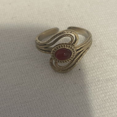Gold-colored ring with red stone
