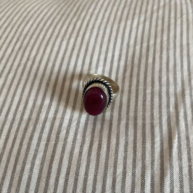 silvery ring with red stone