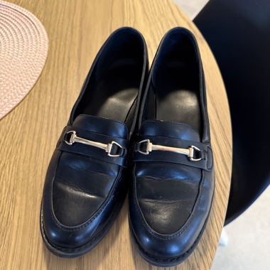 Black loafers with metal bar