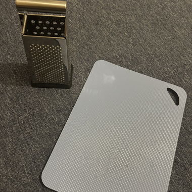 Stainless steel grater and blue cutting board - Set